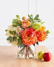 Realistic artificial flowers in a glass vase