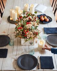 Table with place settings and artificial flower centerpiece